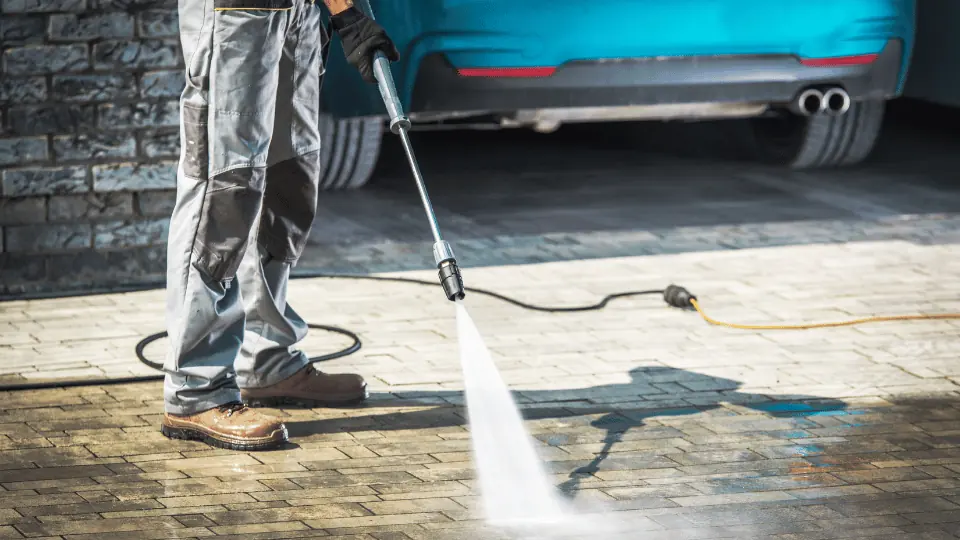 Pressure washer cleaning block paving on a driveway